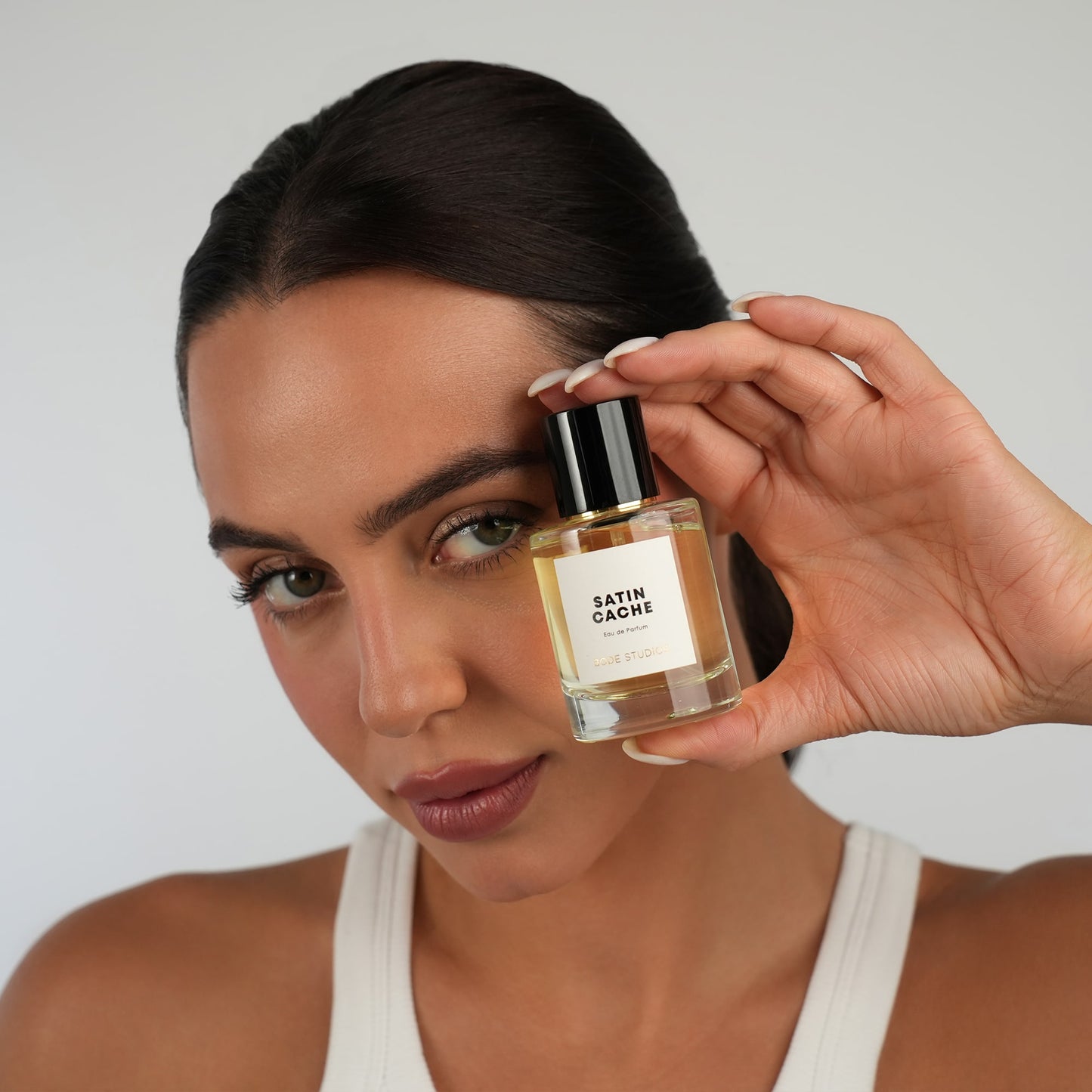 woman holding a perfume by BODÉ STUDIOS to show the perfume collection